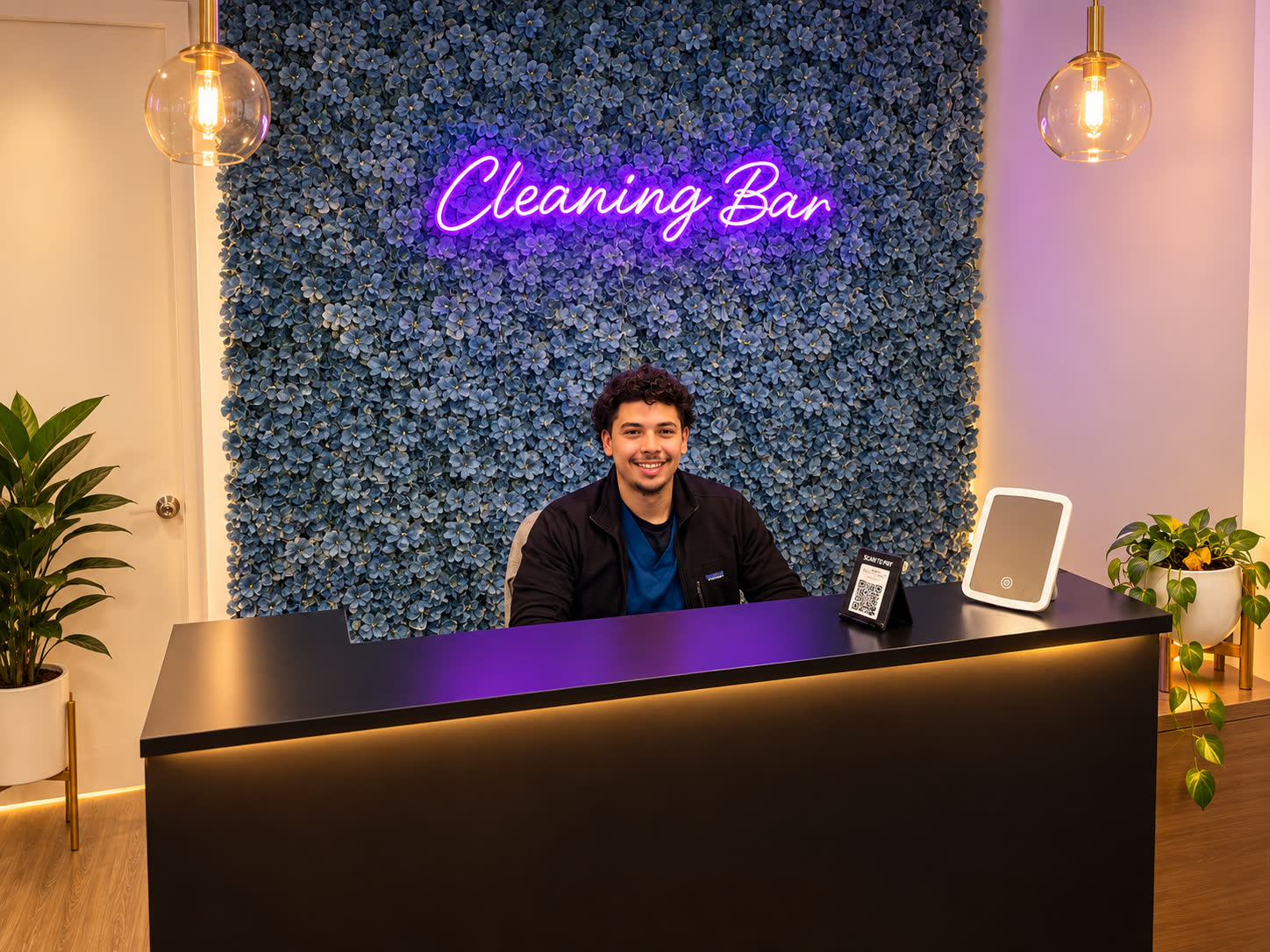 HearWell Cleaning Bar desk with neon sign — hearing aid and headphone deep cleaning